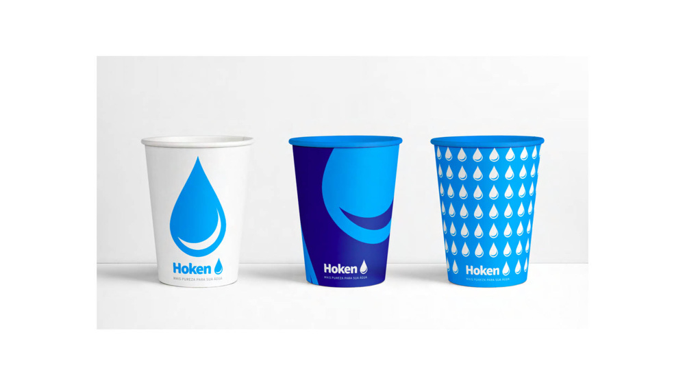 Three Hoken paper cups in white, navy and blue with water-drop patterns.